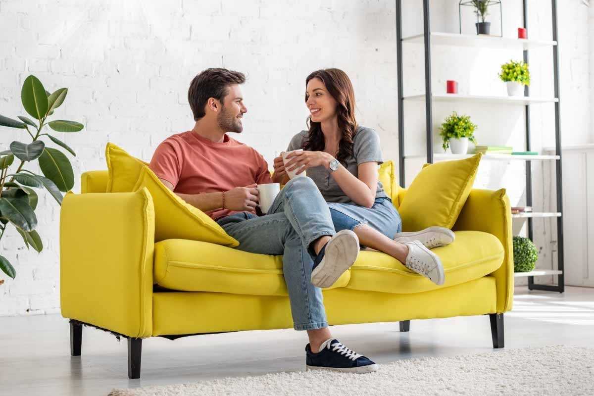 white couple sitting on couch talking Revive Connection in Your Relationship