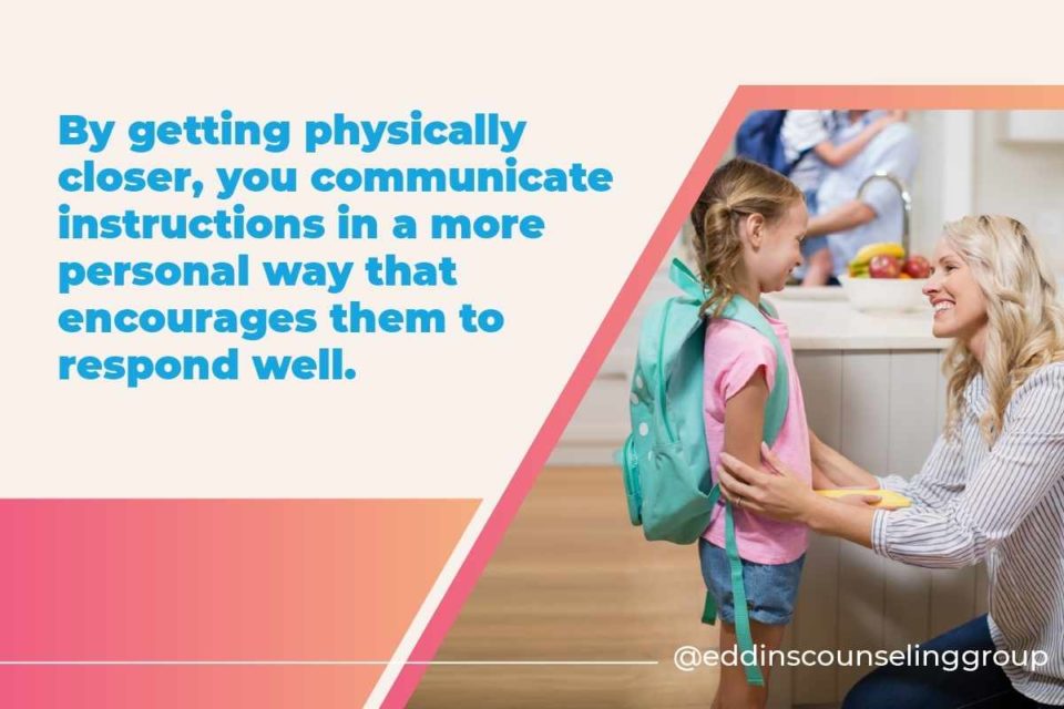 mom kneeling down to talk to child after school get physically closer to child to communicate effectively so children will listen
