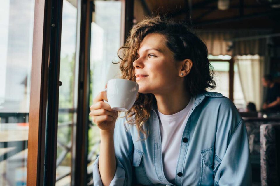 woman sipping on coffee
