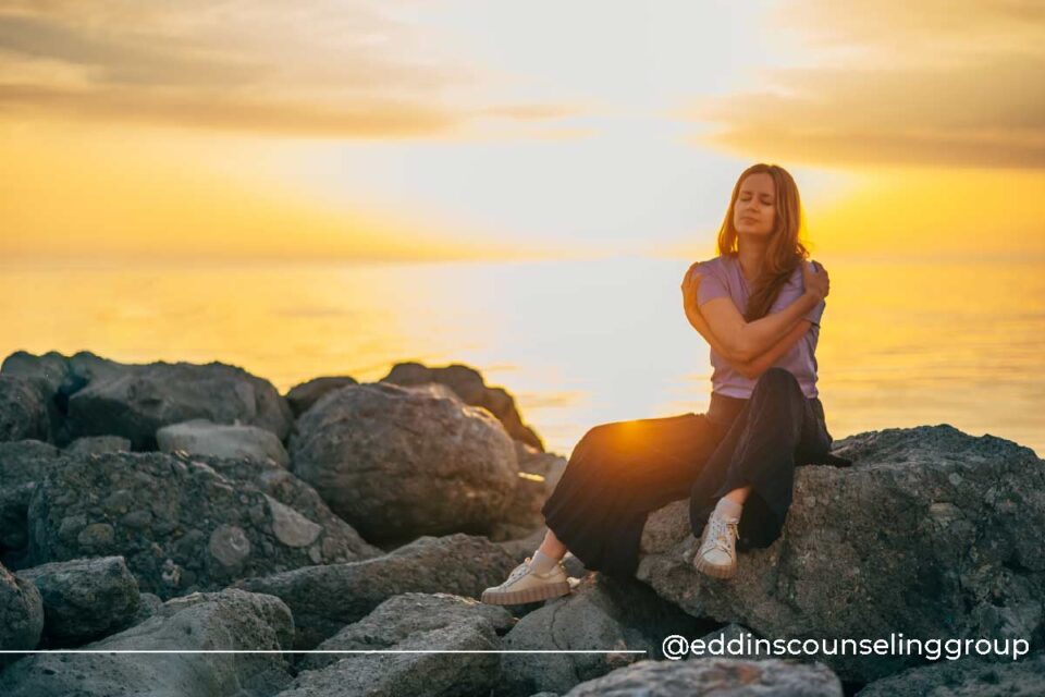 woman hugging herself, self-love and self-compassion