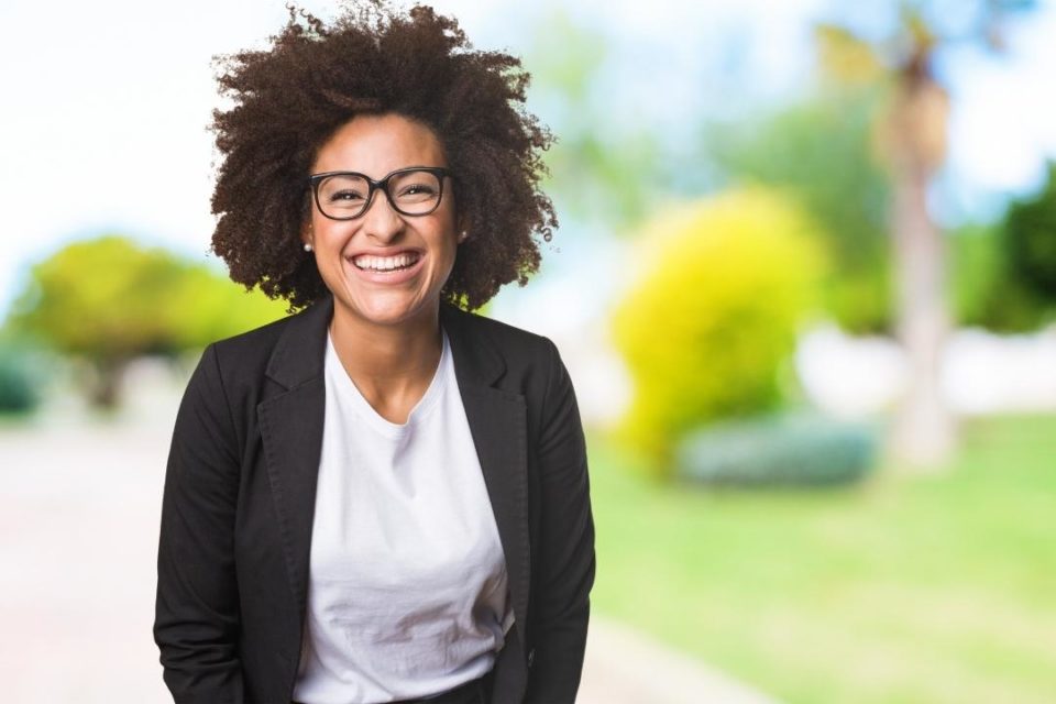 bi-racial smiling woman assertive communication tips