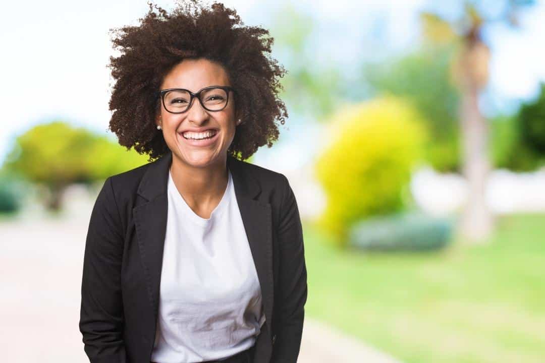 bi-racial smiling woman assertive communication tips