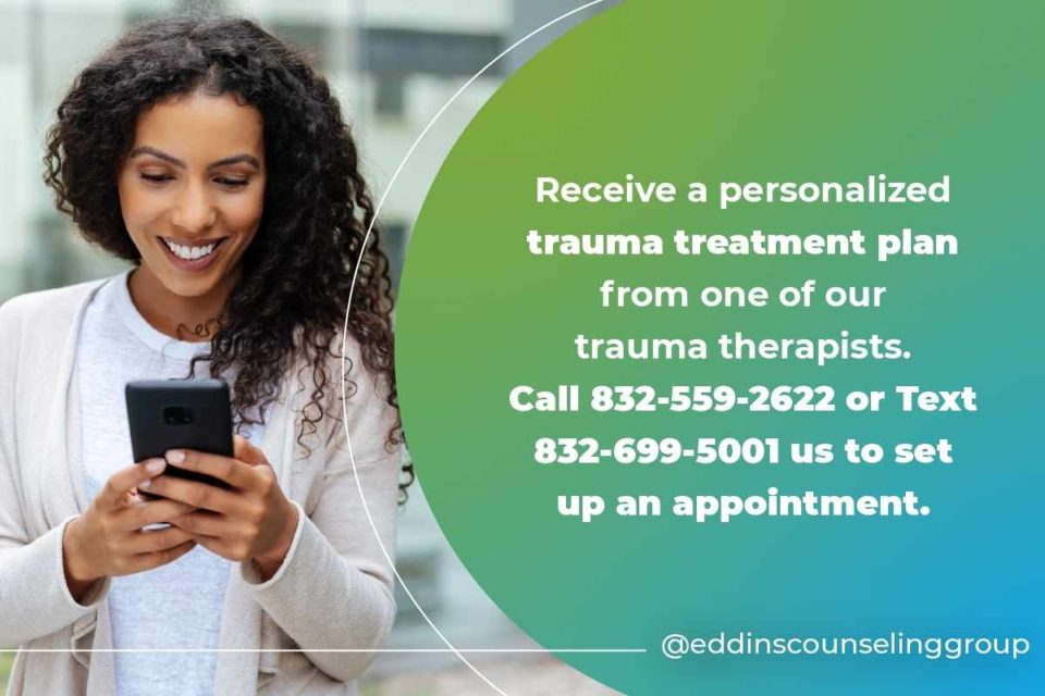 woman smiling while texting her trauma therapist 