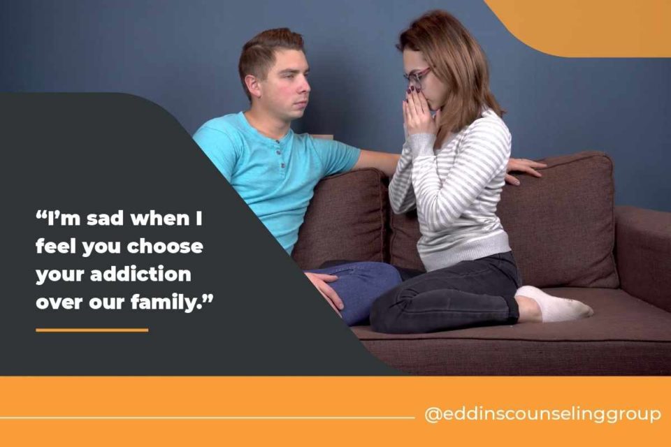 husband and wife sitting on couch confronting each other about addiction