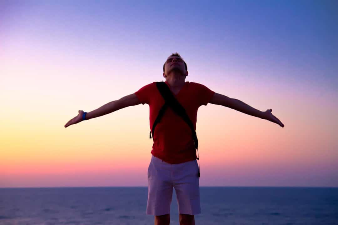 man with arms wide open