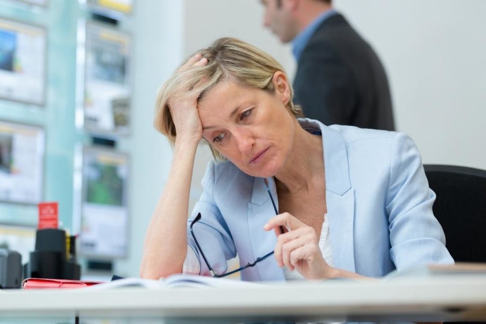 Coping with job loss middle age white woman stressed at work