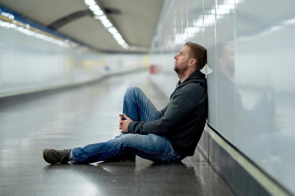 Depression vs Sadness white depressed man sitting in subway