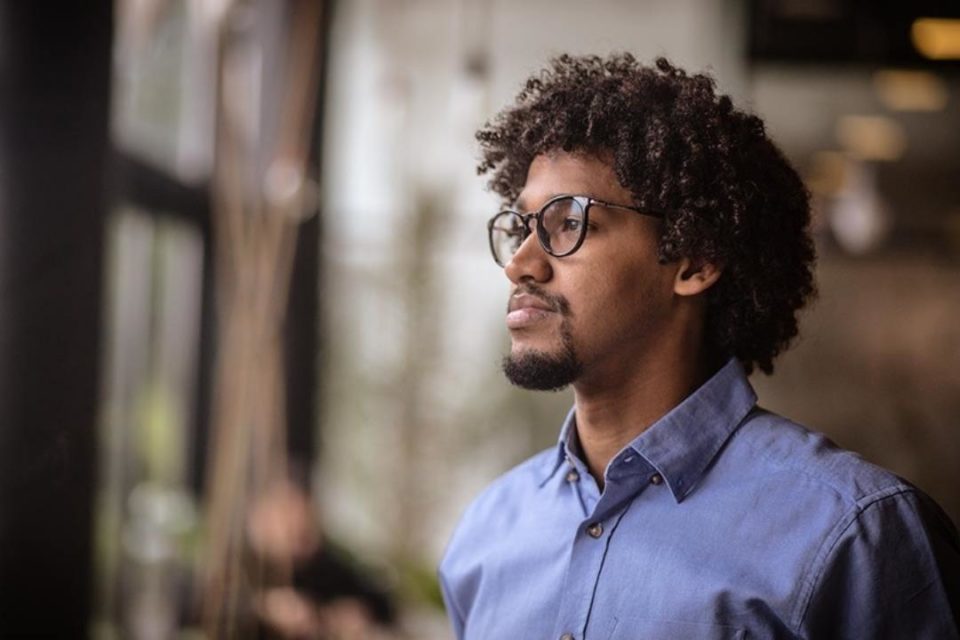 Emotional Health vs. Mental Health: The Real Difference black man staring off into distance