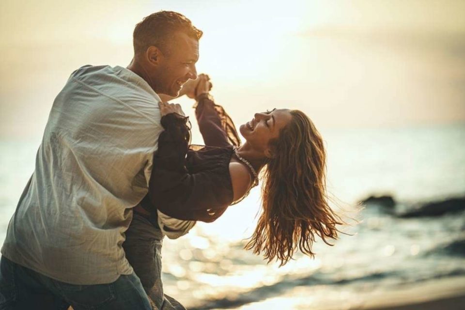 couple dancing by the beach