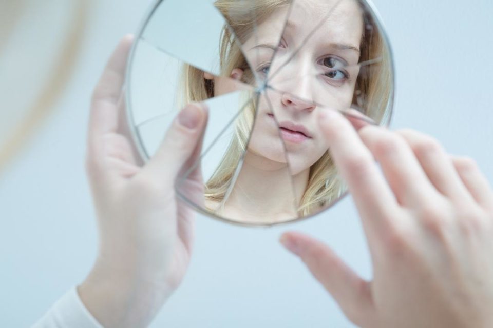 sexual assault counseling white woman broken mirror self-reflection