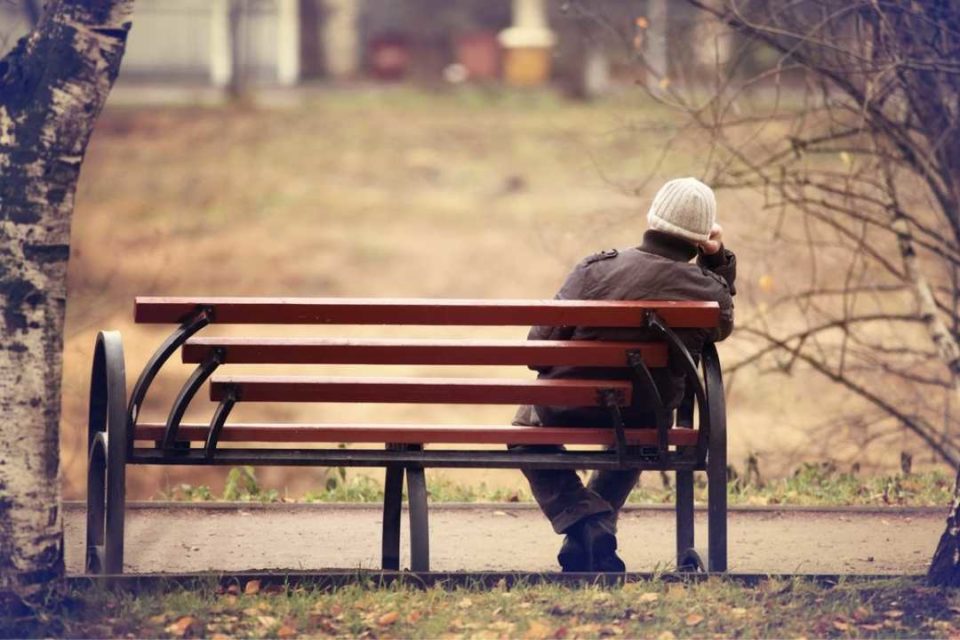 man with anxiety sitting on bench