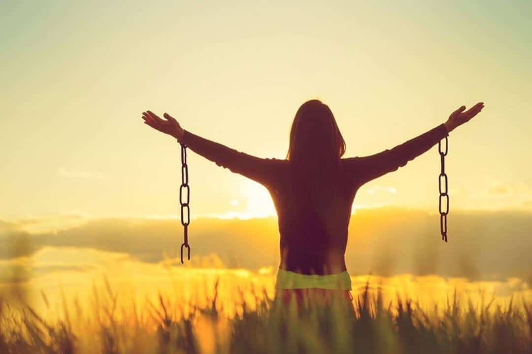 What Self-Harm Is & How Self-Harm Happens woman unchained in field