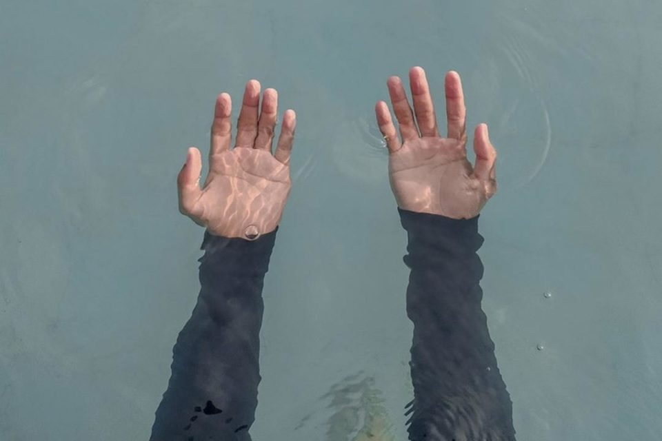 Why Depression Needs to Be Talked About hands underwater