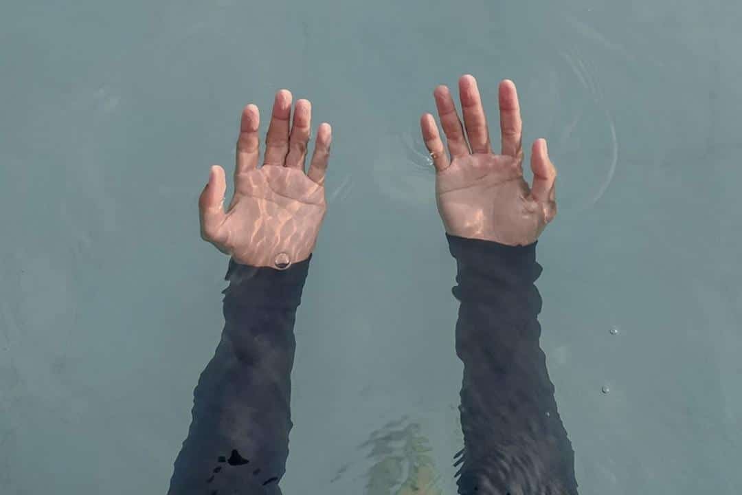 Why Depression Needs to Be Talked About hands underwater