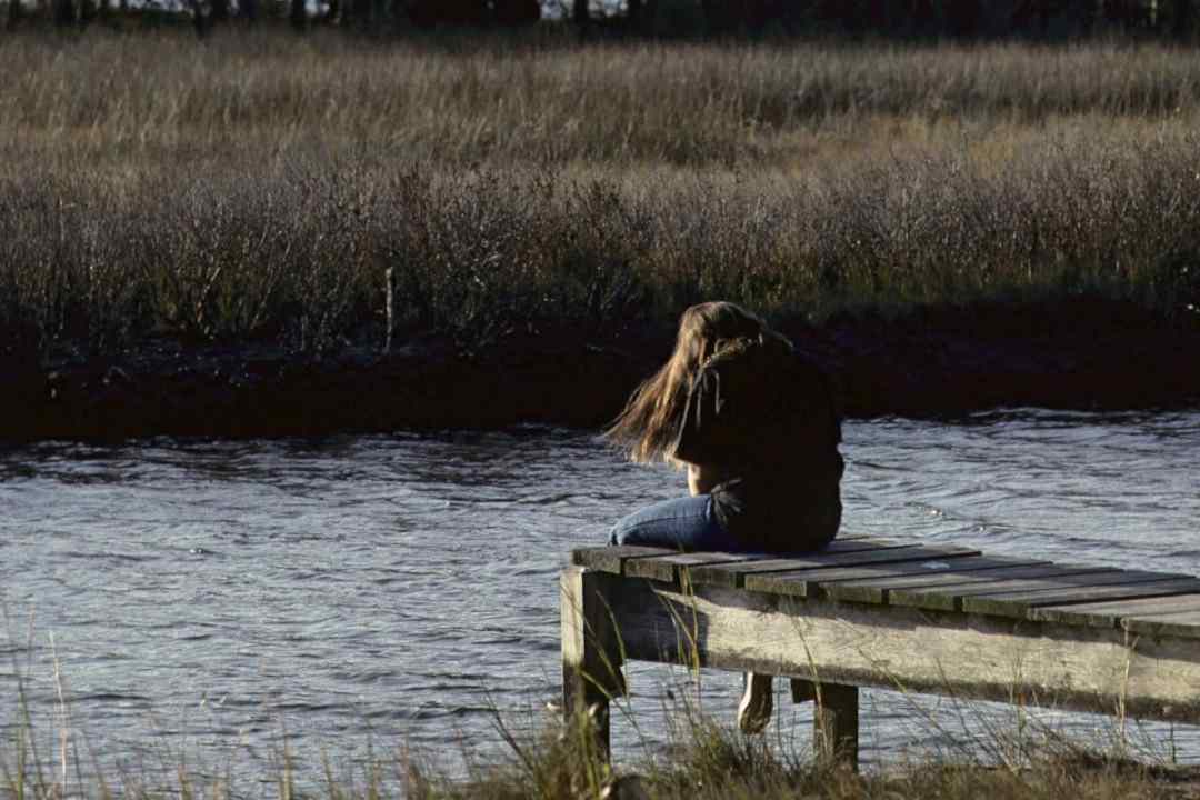teen withdrawing on pier