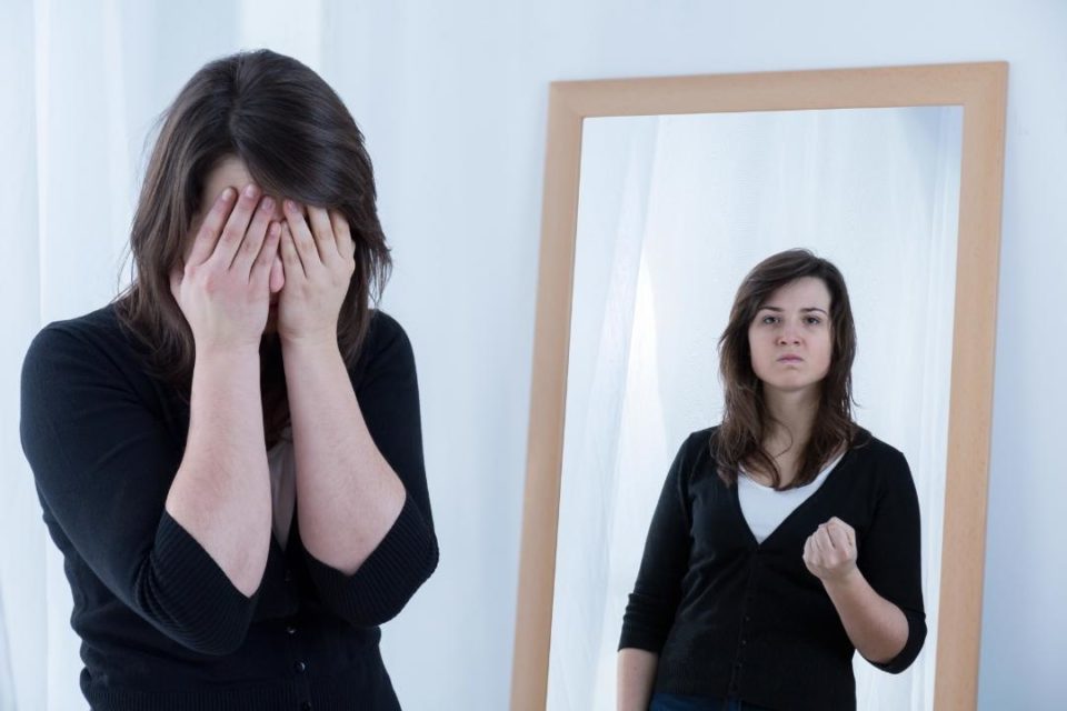 inner critic woman in mirror reflection