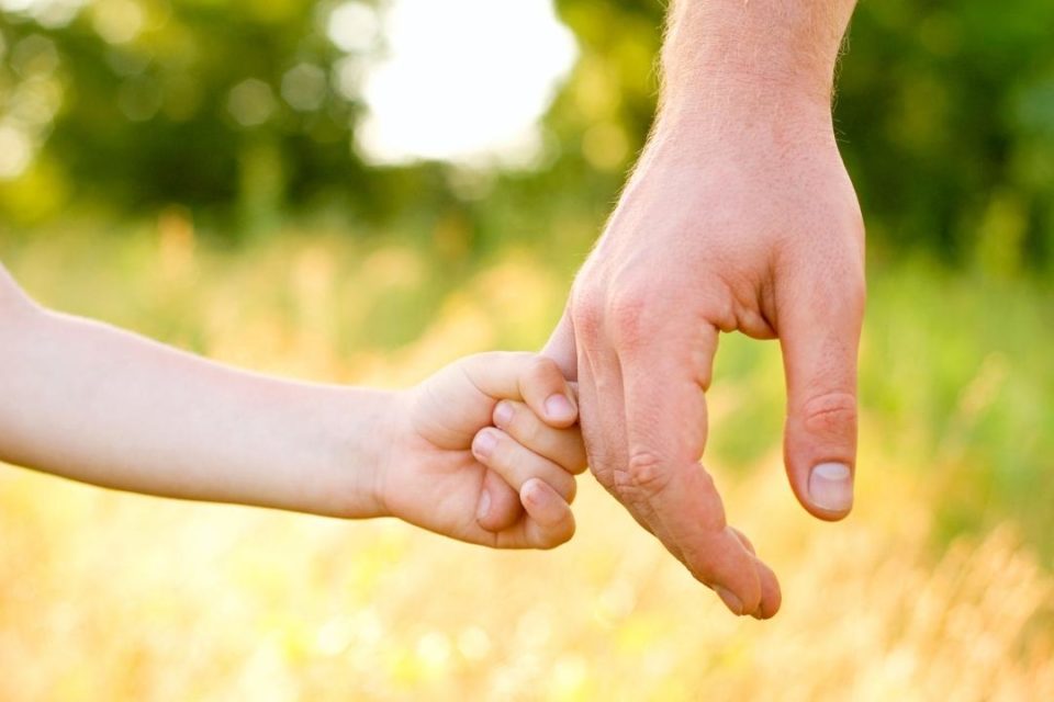 son holding fathers hand Your Nest is Empty – 5 Ways to Beat the Loneliness