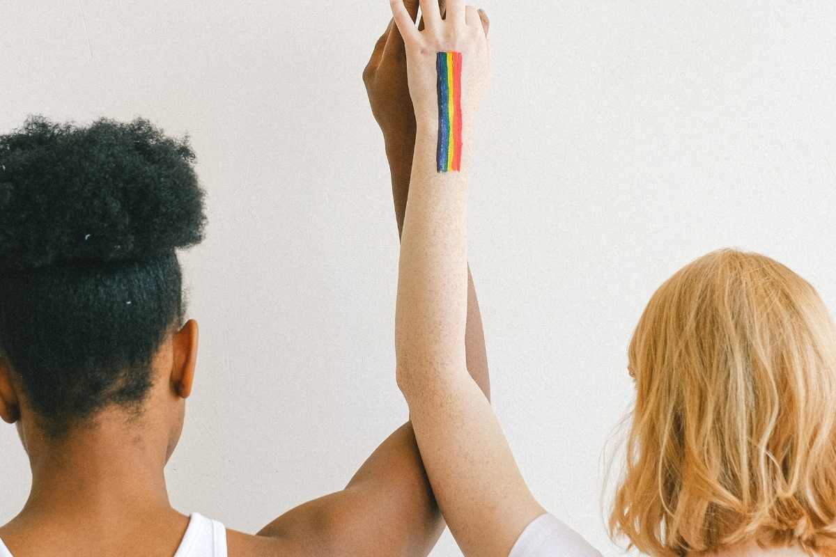 Image of two women holding hands with a rainbow flag painted on them. Are you searching for "LGBTQ+ counseling near me" in Houston, TX? What about "LGBTQ couples therapy near me"? Our LGBTQ therapists in Texas are here for you! Start exploring your sexuality with LGBTQIA+ therapy in Houston, TX. Call now!