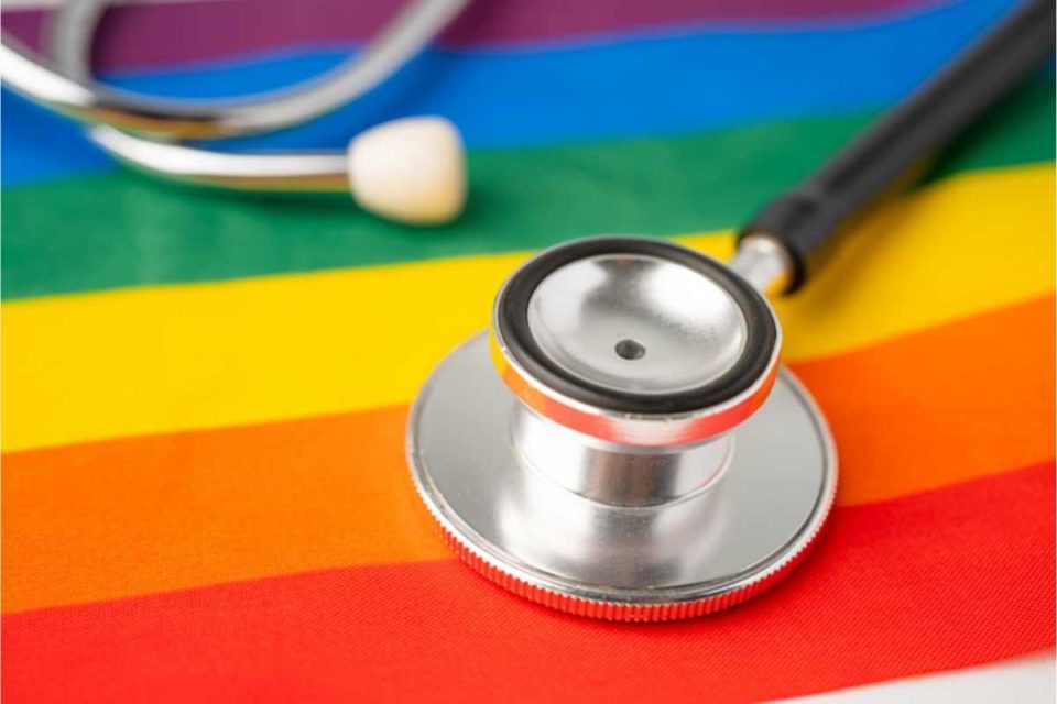 affirming lgbtq identity represented by stethoscope on rainbow flag