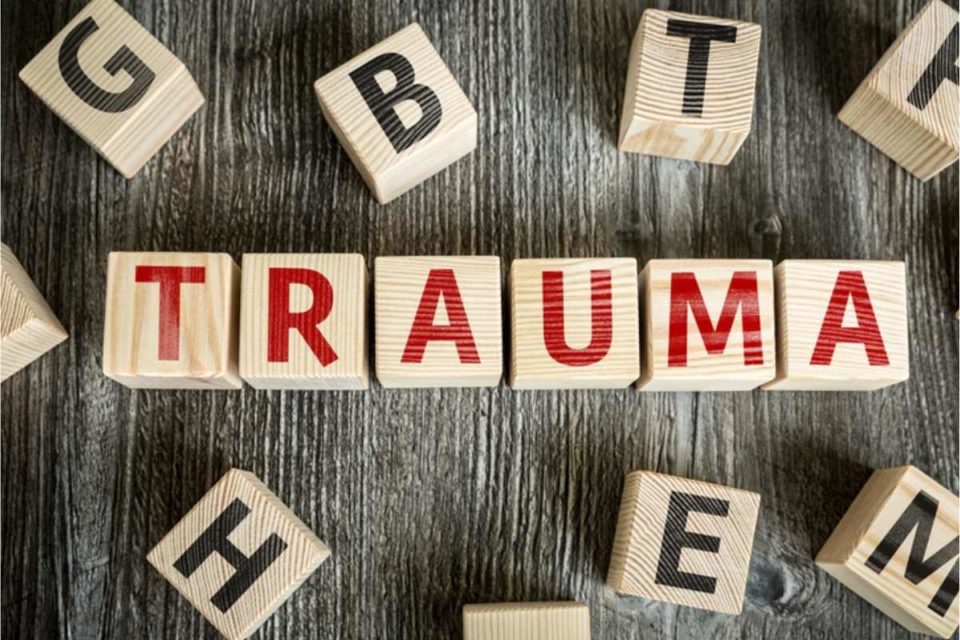 Image of Trauma spelled out in red on wood blocks. Trauma symptoms reoccur because it stays in our bodies. We can help with PTSD treatment & trauma therapy in Houston, TX 77009. Get started with a trauma therapist in Sugar Land, TX 77478. Call today! 