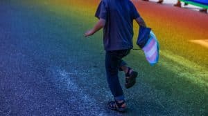 transgender child running down the street 