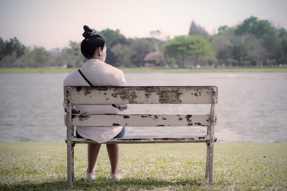 Image of a woman sitting and looking out at a lake. what is an anxiety disorder? Our anxiety therapist in Houston, tx can answer that question. Get help today with anxiety treatment in Houston, TX 77008. As well as anxiety treatment in Sugar Land, TX 77478. Call today!